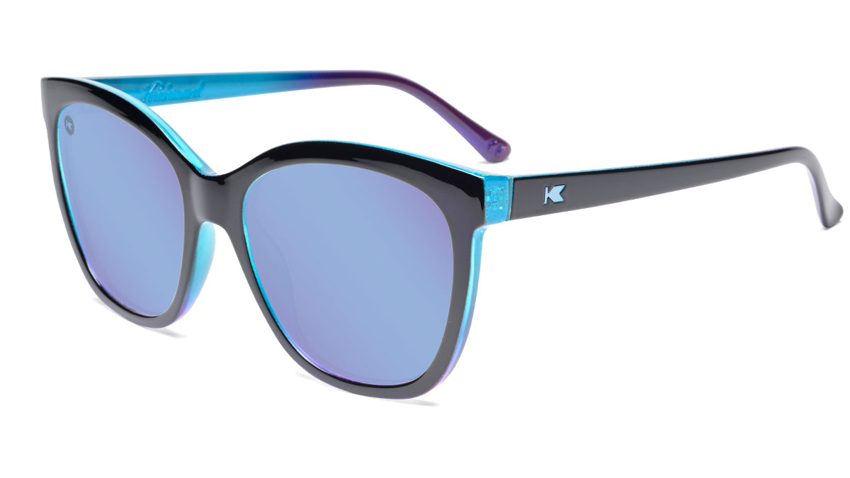 Sunglasses with Glossy Black Exterior and Ice Blue to Lavender Interior and Polarized Snow Opal Lenses. Flyover