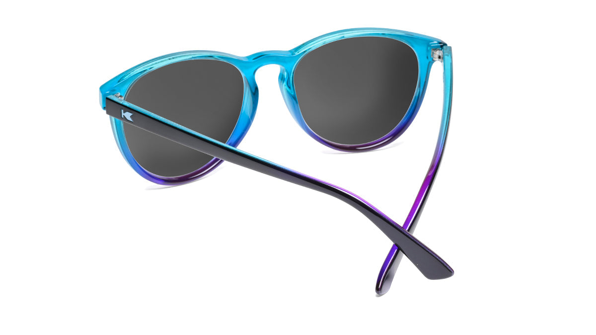 Sunglasses with Glossy Black Exterior and Ice Blue to Lavender Interior and Polarized Snow Opal Lenses. Back